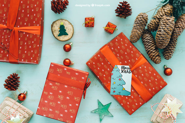 Free Christmas Mockup With Present Boxes And Pine Cones Psd