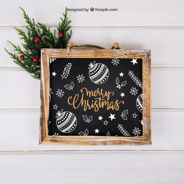 Free Christmas Mockup With Slate Above Mistletoe Psd