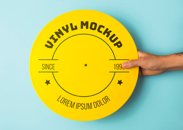 Free Close Up Hand Holding Yellow Vinyl Mockup Psd