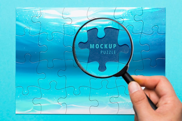 Free Close-Up Man Holding Magnifying Glass Psd