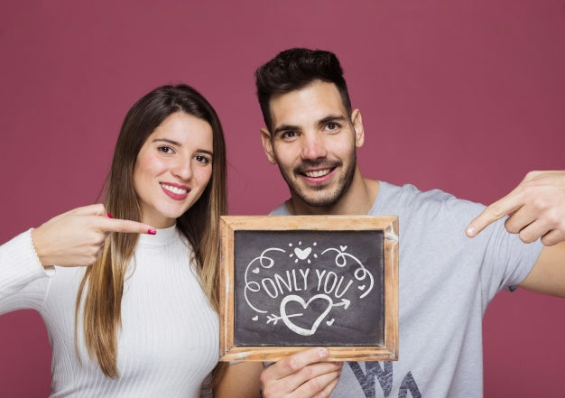 Free Couple Presenting Slate Mockup Psd