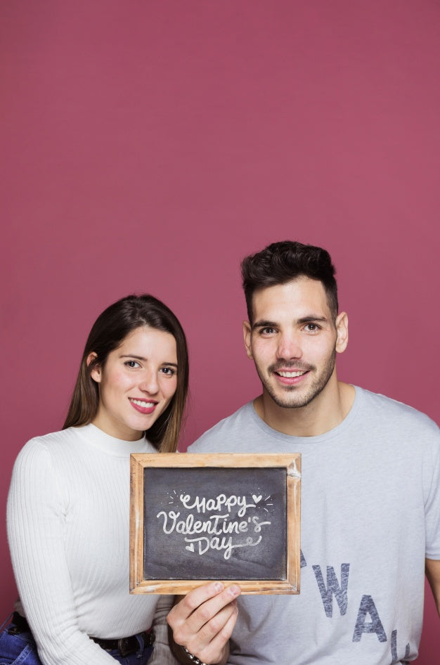 Free Couple Presenting Slate Mockup Psd