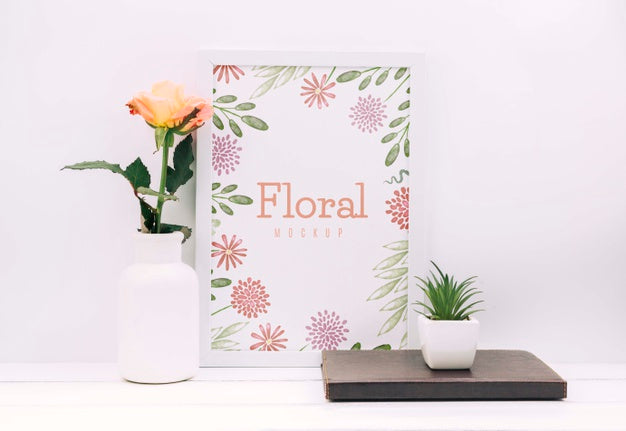 Free Desk Composition With Flower Decor And Frame Mockup Psd