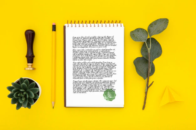 Free Flat Lay Of Desk Surface With Notebook And Leaves Psd