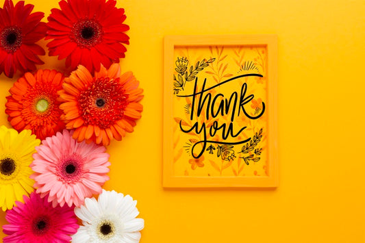 Free Flat Lay Of Frame And Flowers On Yellow Background Psd