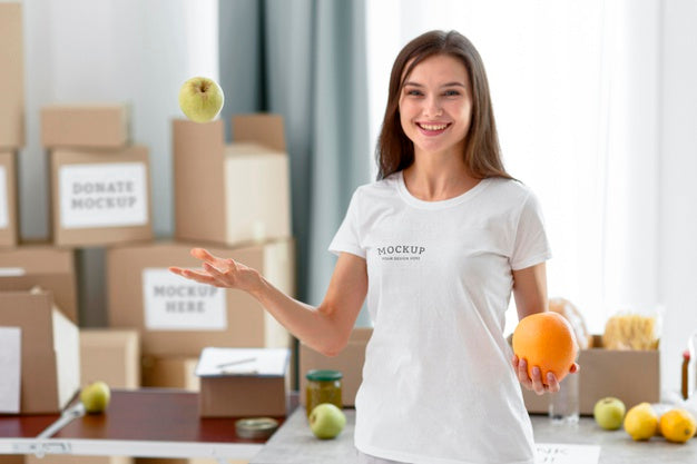 Free Front View Of Smiley Female Volunteer Tossing Apple In The Air Psd