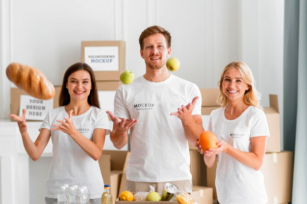 Free Front View Of Smiley Volunteers Preparing Boxes With Food For Donation Psd