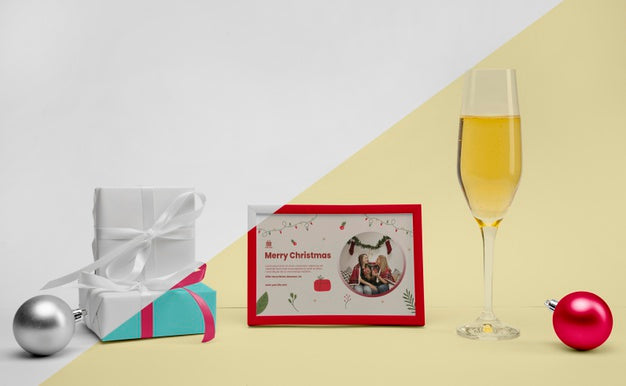 Free Glass Of Champagne Next To A Frame With Mock-Up Psd