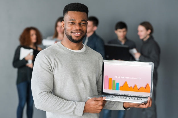 Free Group Of People Holding Laptop Mockup For Charity Psd