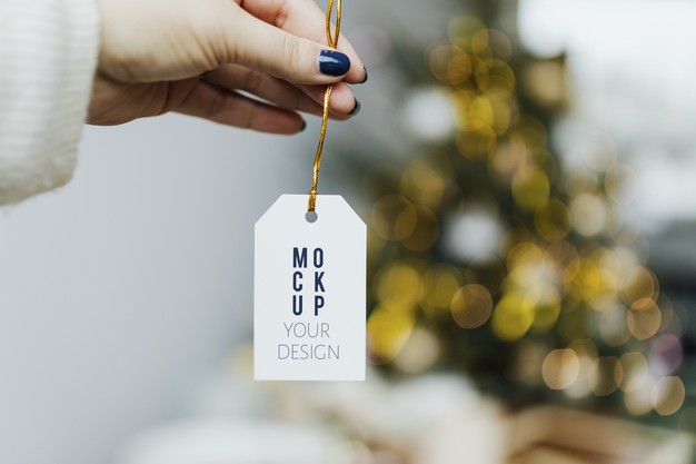 Free Hand Holding Christmas Tag Template Psd