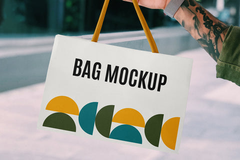 Free Hand Holding Mini Shopping Bag Mockup