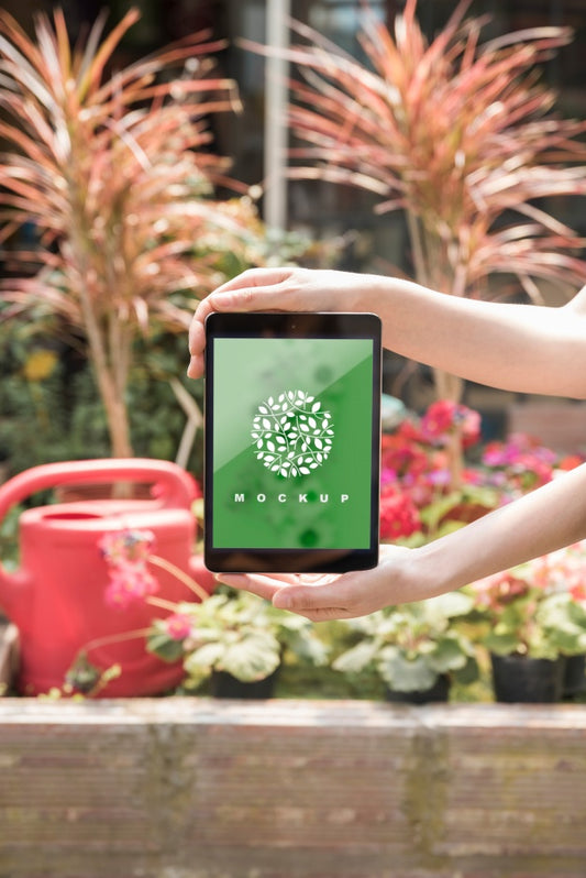 Free Hands Holding Tablet Mockup With Gardening Concept Psd