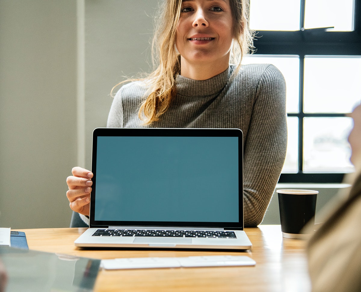 Free Happy Woman With A Blank Laptop Screen