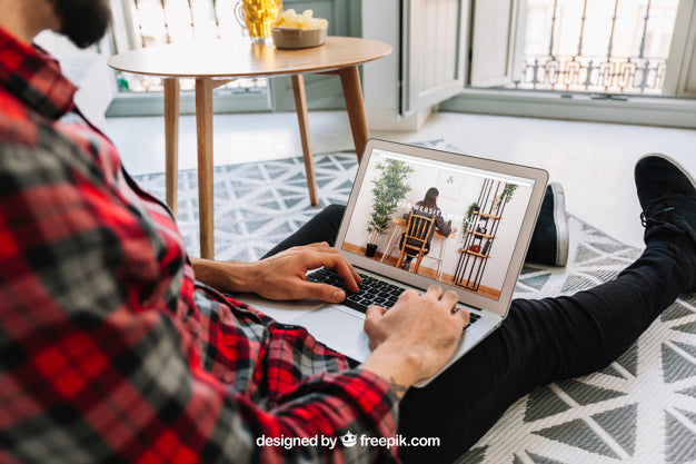 Free Home Office Concept With Man On Floor Using Laptop Psd