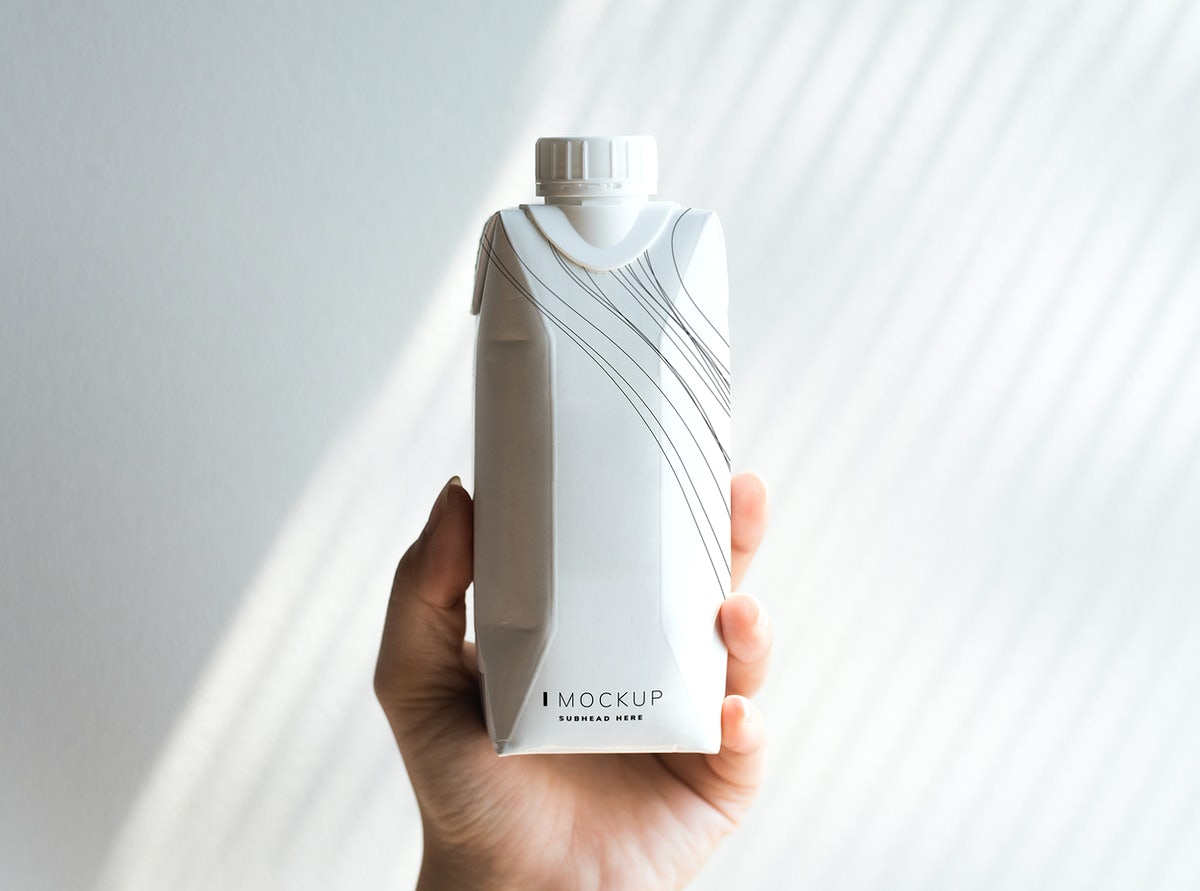 Free Human Hand Holding Paper Bottle Mockup