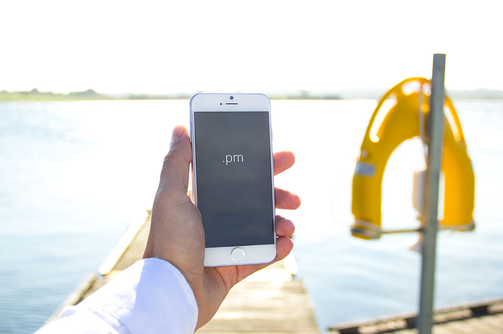 Free White iPhone 6 in a Mans Hand Mockup