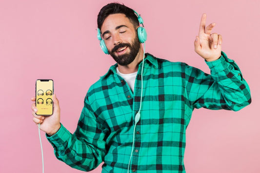 Free Joyful Young Man With Headphones And Cell Phone Mock Up Psd