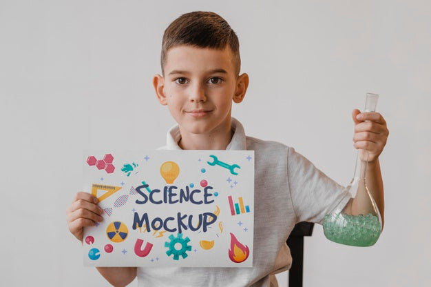 Free Kid Holding A Card Mock-Up While Learning Science Psd