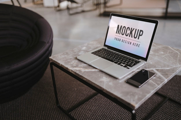 Free Laptop And A Phone On A Marble Table Psd