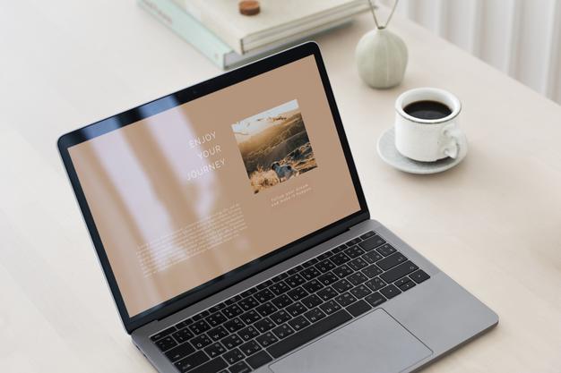 Free Laptop Mockup On A Wooden Table Psd