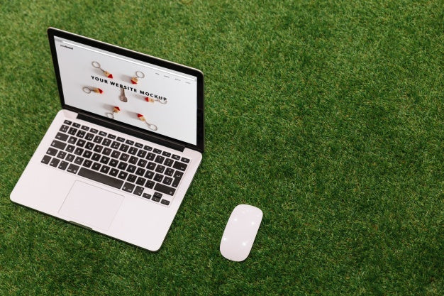 Free Laptop Mockup On Grass Psd