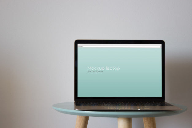 Free Laptop Mockup On Round Table Psd