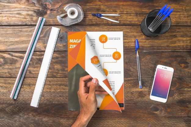 Free Magazine And Smartphone Mockup On Wooden Table With Pens And Rulers Psd