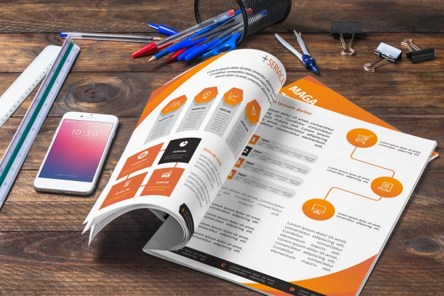 Free Magazine And Smartphone Mockup On Wooden Table With Pens And Rulers Psd