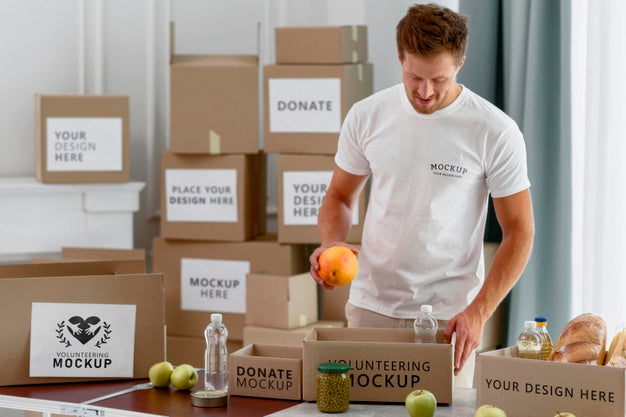 Free Male Volunteer Preparing Donation Box With Provisions Psd