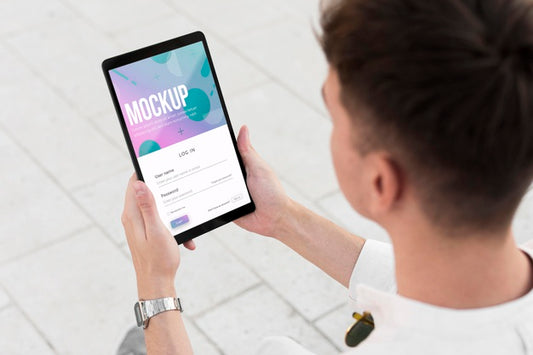 Free Man Holding A Mock-Up Tablet Outside Psd