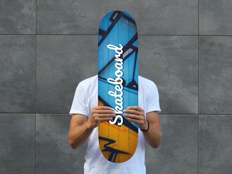 Free Man Holding Skateboard Psd Mockup