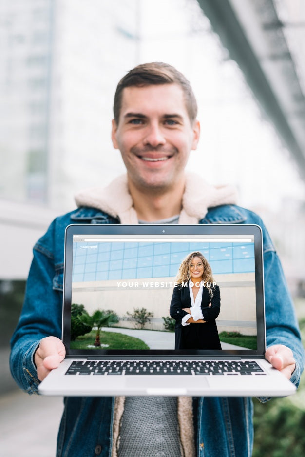 Free Man Presenting Laptop Mockup Psd