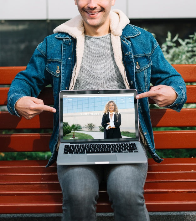 Free Man Presenting Laptop Mockup Psd