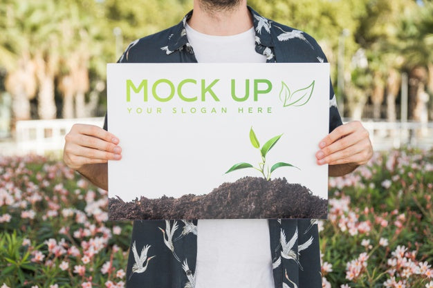 Free Man Presenting Poster Mockup In Front Of Park Psd