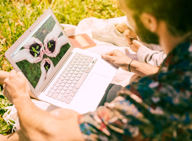 Free Man Using Laptop Mockup In Nature Psd