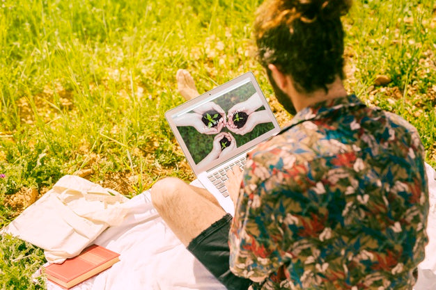 Free Man Using Laptop Mockup In Nature Psd