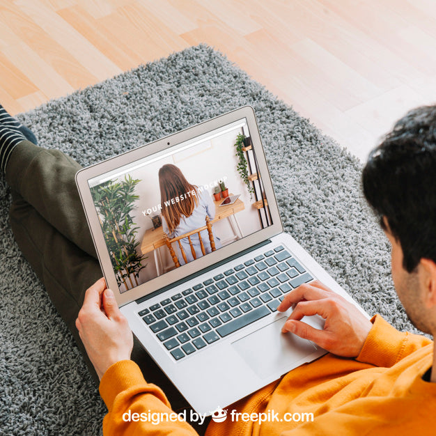 Free Man Using Laptop On Floor Psd