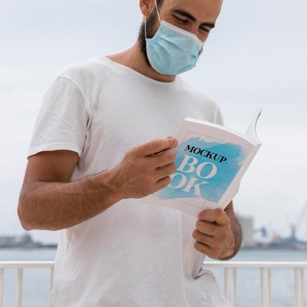 Free Man With Mask On Street Reading Book Psd