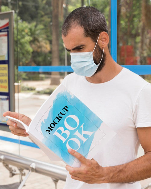 Free Man With Mask On Street Reading Book Psd