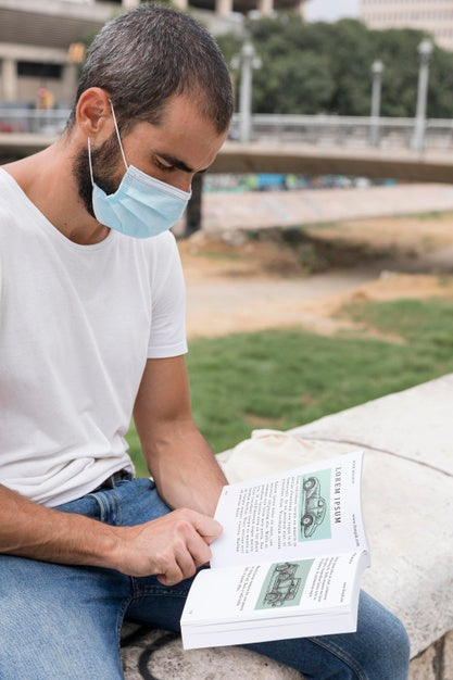 Free Man With Mask On Street Reading Book Psd