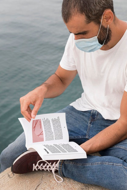 Free Man With Mask On Street Reading Book Psd