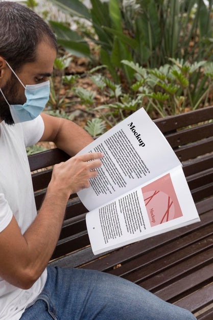 Free Man With Mask On Street Reading Book Psd