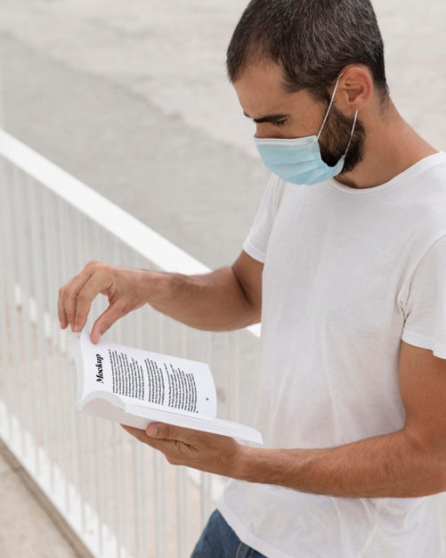 Free Man With Mask On Street Reading Book Psd