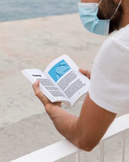 Free Man With Mask On Street Reading Book Psd