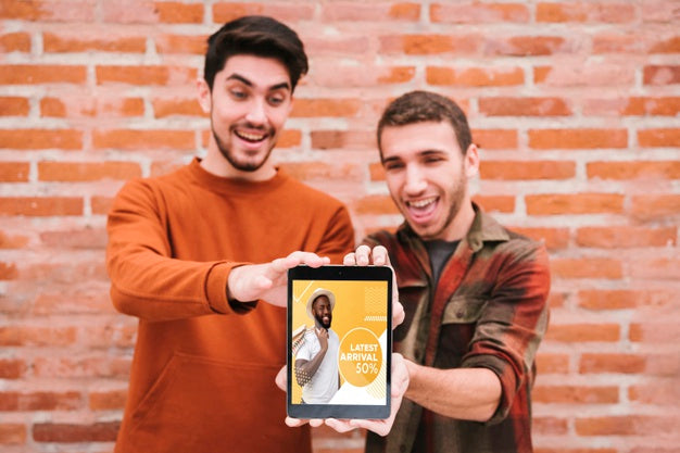 Free Medium Shot Happy Guys Holding Up Tablet Psd