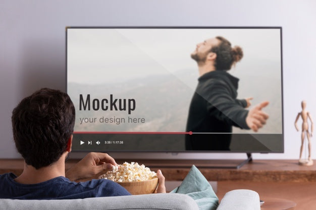 Free Medium Shot Man Watching Movie On Tv Psd