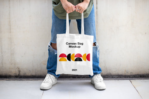 Free Men Holding Canvas Bag Mockup