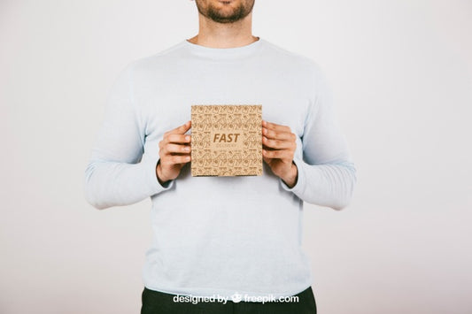 Free Mock Up With Man Holding A Carton Box Psd