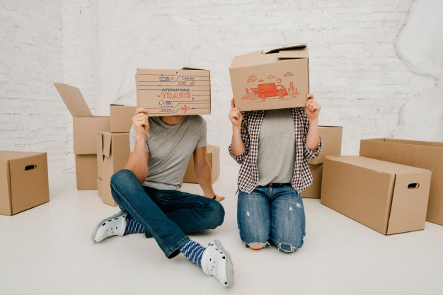 Free Mockup Of Couple With Cardboard Boxes Psd