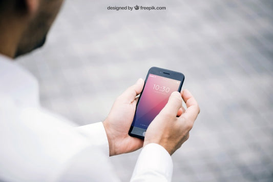 Free Mockup Of Man Looking At Smartphone Psd